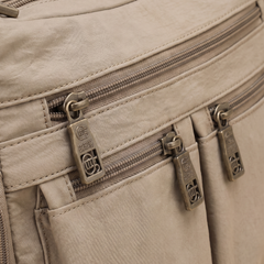 Kia crossbody bag, close-up of the front zip pockets