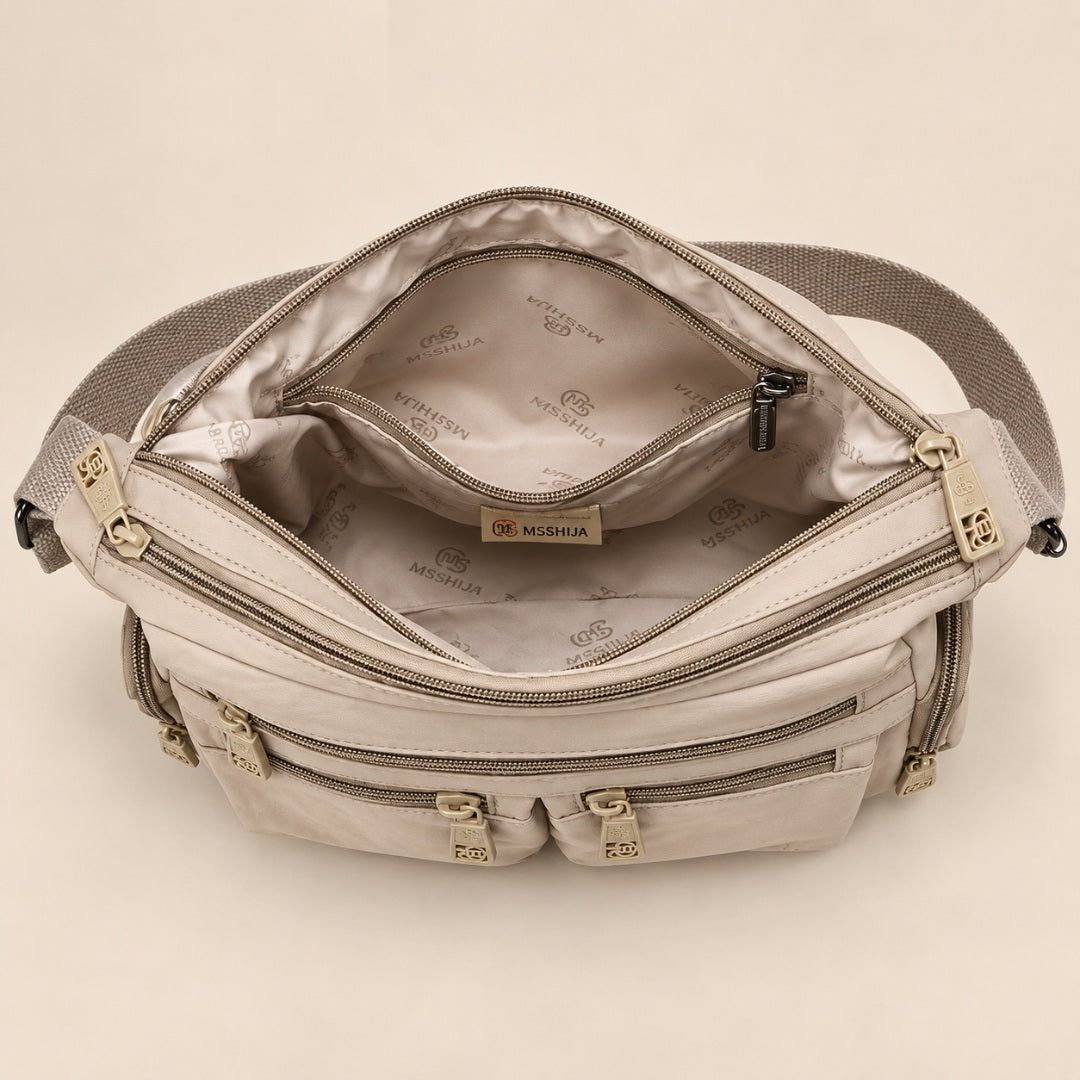 Kia crossbody bag, inside with the zip compartments
