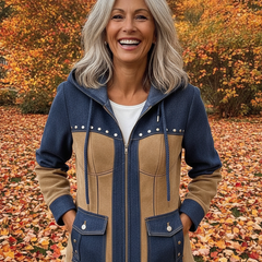 Woman laughing in the navy and camel hooded jacket in an autumn garden